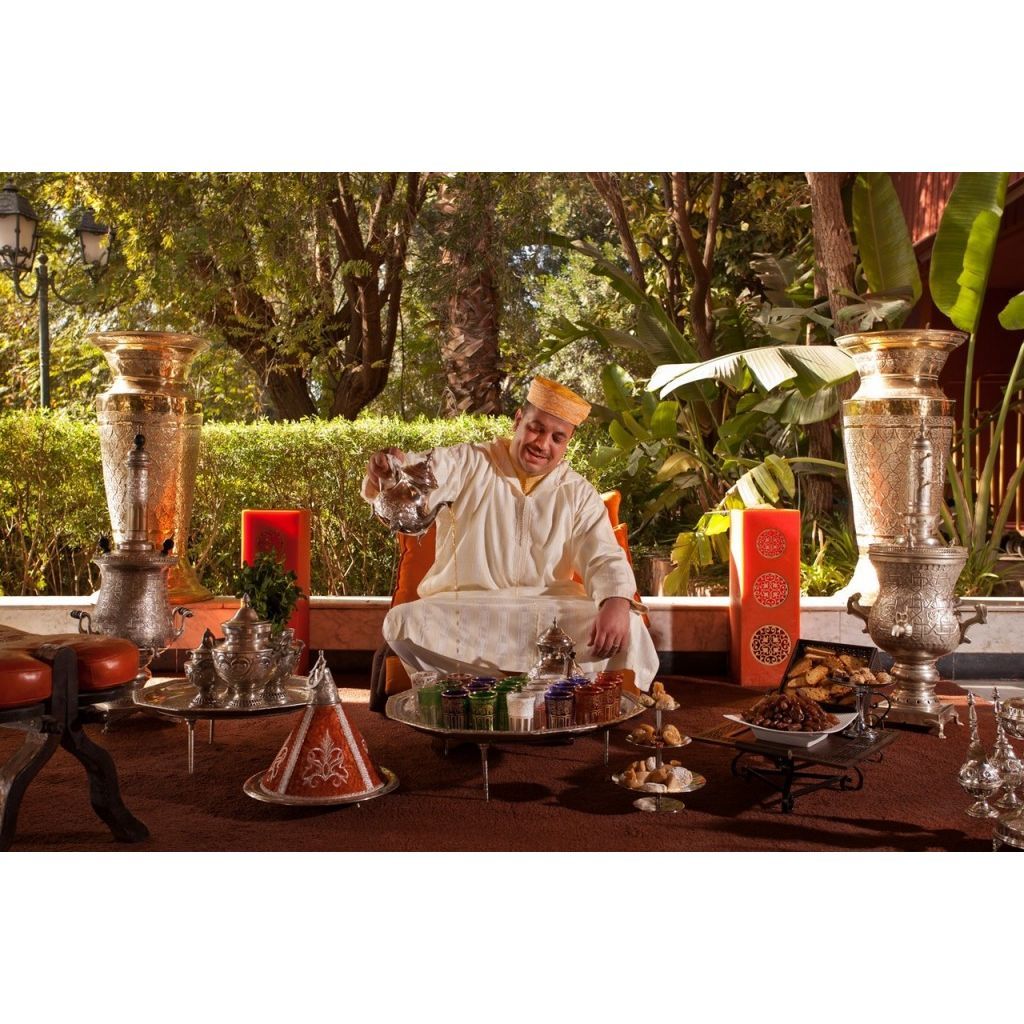 moroccan man pouring tea into a cup